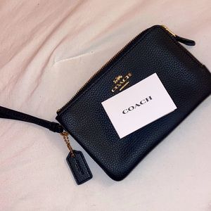Coach small little wallet with two zippers for extra space.